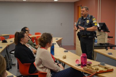 Police officer teaching students